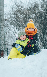 Sister and brother playing with snow