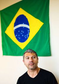 Man against flag on wall