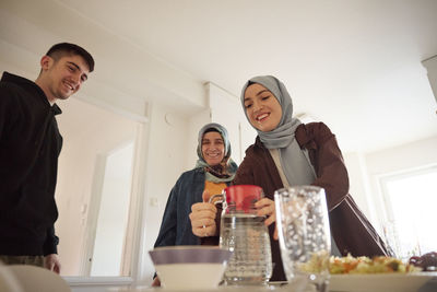 Family setting table for eid al-fitr together at home