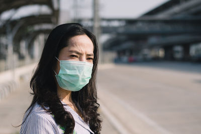 Woman wearing mask while standing in city