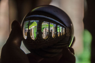 Close-up of human hand holding camera