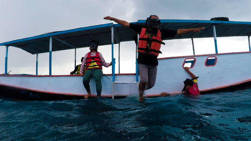 People by boat in sea