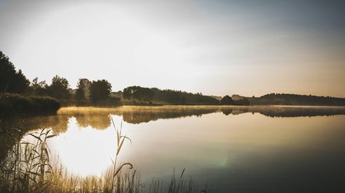 Scenic view of lake against sky during sunset