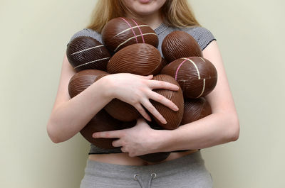 Midsection of woman holding chocolate easter eggs