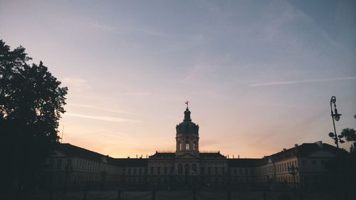 Low angle view of building against sky at sunset