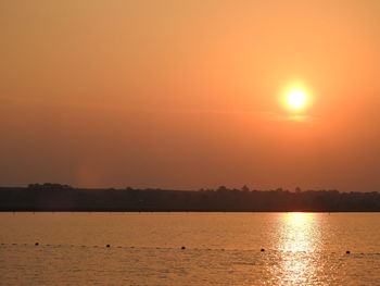 Scenic view of sea against orange sky