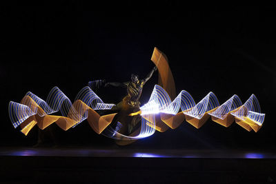 Man with light painting performing on stage