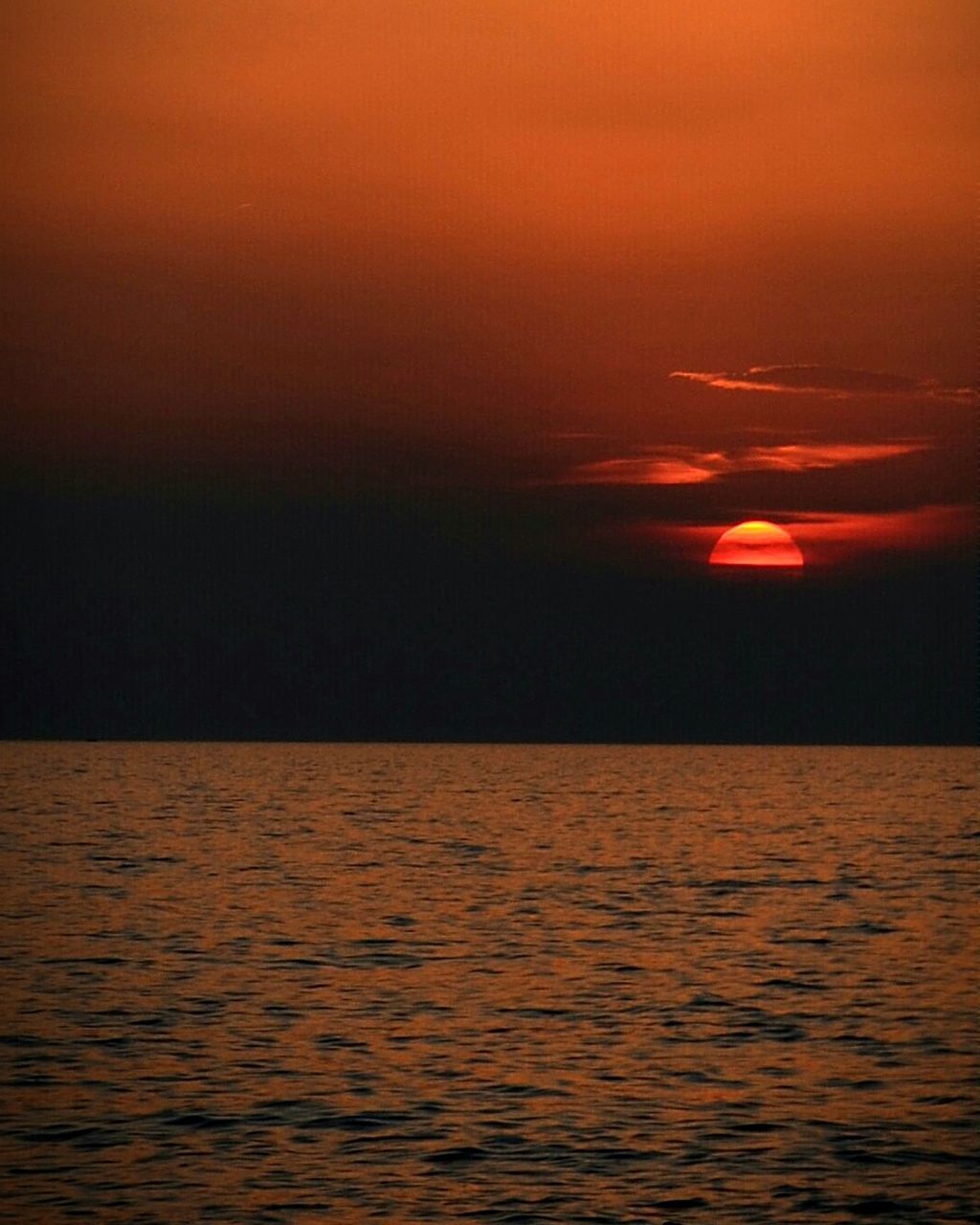 sunset, water, waterfront, scenics, tranquil scene, orange color, tranquility, beauty in nature, sea, rippled, idyllic, nature, sky, horizon over water, no people, outdoors, reflection, silhouette, remote, seascape