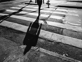 Low section of person walking on crosswalk