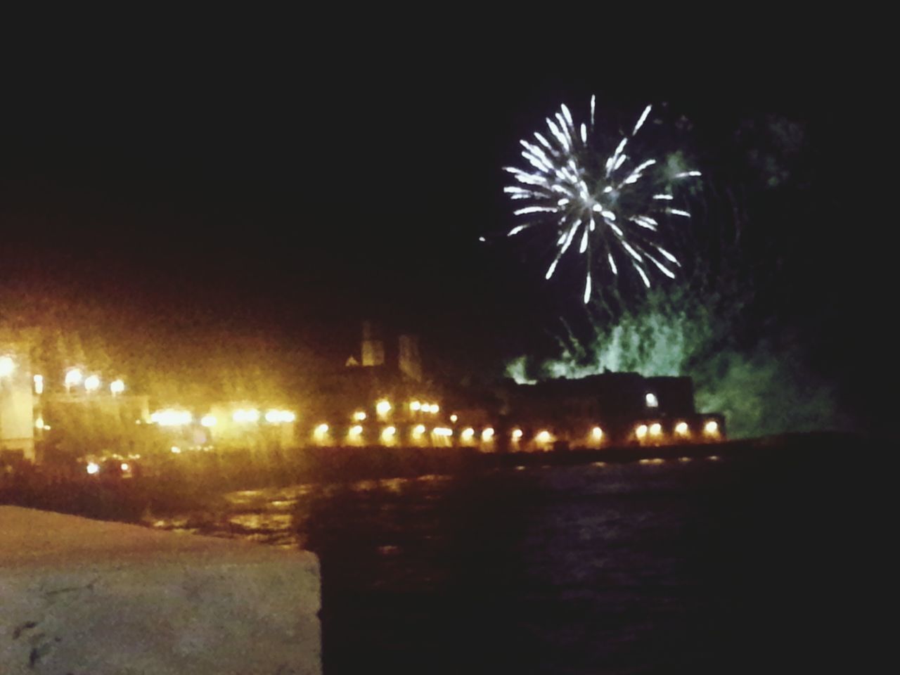 night, illuminated, long exposure, glowing, firework display, motion, water, street, reflection, sky, building exterior, lighting equipment, no people, outdoors, dark, built structure, celebration, blurred motion, architecture, exploding