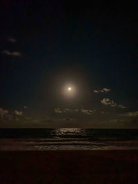 Scenic view of sea against sky at night