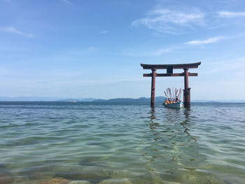 Lifeguard hut on sea against sky