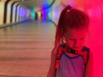 Close-up of girl looking at illuminated lamp