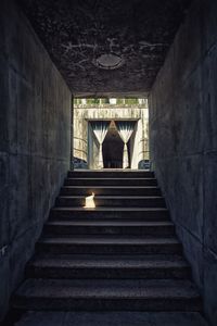 Rear view of people walking on staircase in building