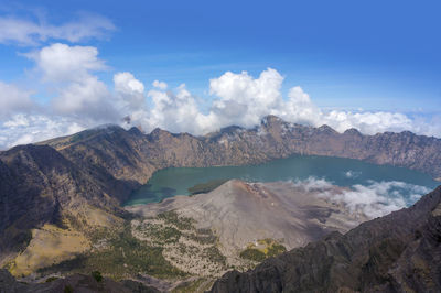 Scenic view of mountains against cloudy sky