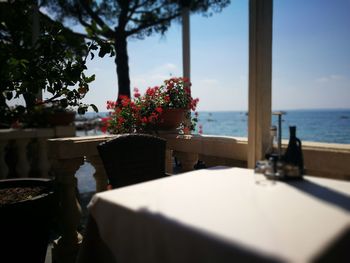 Chair and table at restaurant by lake garda