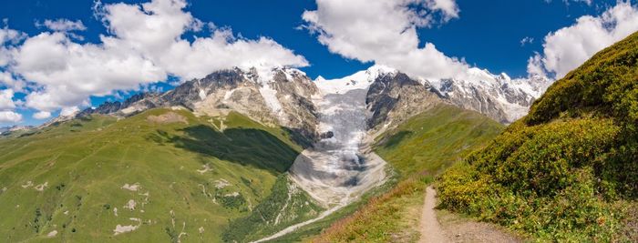 Panoramic view of snowcapped mountains against sky