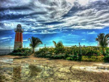 Lighthouse against cloudy sky