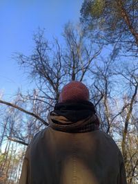 Rear view of person wearing hat against sky