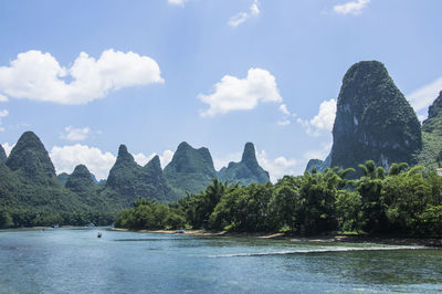 Scenic view of mountains and river against sky