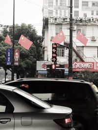 Cars on road against buildings in city