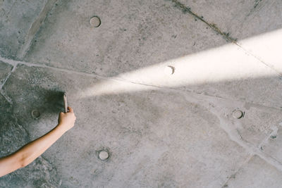 High angle view of woman standing on tiled floor