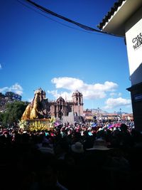 People at temple against sky