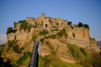 Low angle view of fort against clear blue sky