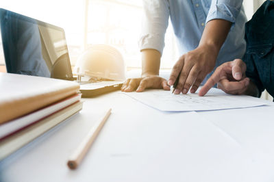 Midsection of man working on table