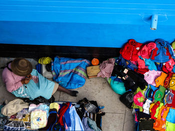 High angle view of vendor sitting by market stall