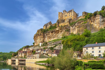 View of beynac-et-cazenac with castle on topof cliff, dordogne department, france