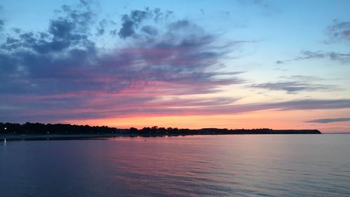 Scenic view of sea against romantic sky at sunset