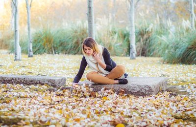 Young woman sitting in park