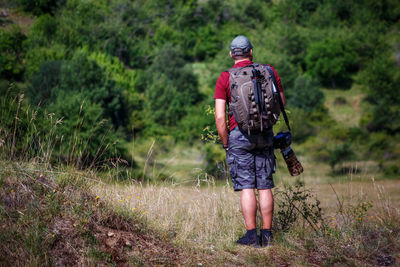 Mountain hiker photographer explores the area for the photographic hunting of wild animals.