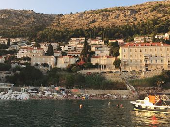 Boats in sea by town