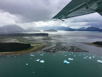 Aerial view of lake and mountains against sky