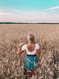 Low section of woman standing on field