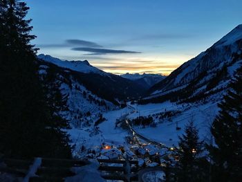 Scenic view of mountains against sky at night during winter