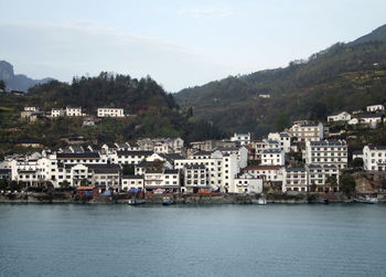 Townscape by sea against sky