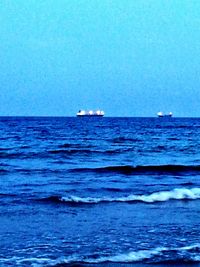 Boat sailing in sea against clear sky