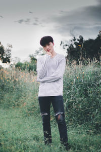 Full length of young man standing on field