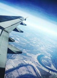 Aerial view of airplane wing against sky