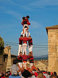 Rear view of people standing against sky