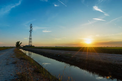 Blue sky and rural paddy field with riverside	
