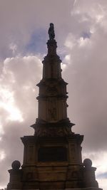 Low angle view of building against cloudy sky