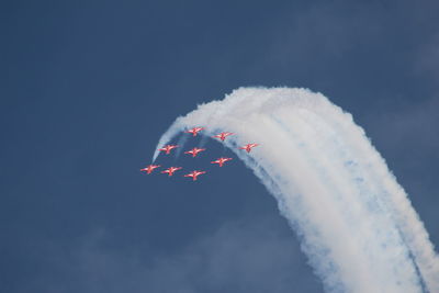 Low angle view of airplane flying against sky