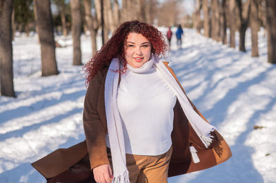 Young woman standing on snow