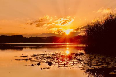 Scenic view of lake against sky during sunset