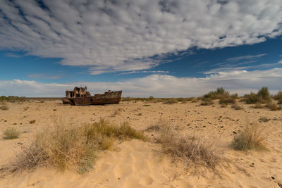 Old and broken ship stranded in the sand, where the aral lake used to be.