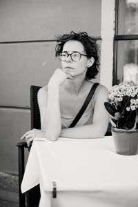 A girl sitting at a street table of a cafe